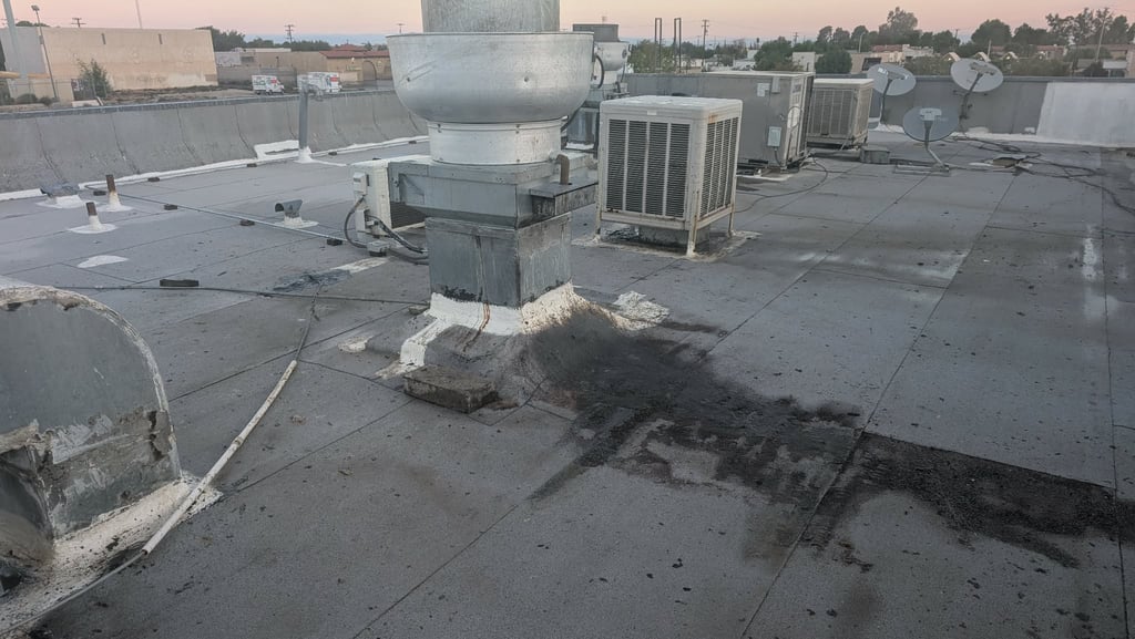 2 years of roof top hood cleaning grease spillage on asphalt roof. Grease will bond to the asphalt.