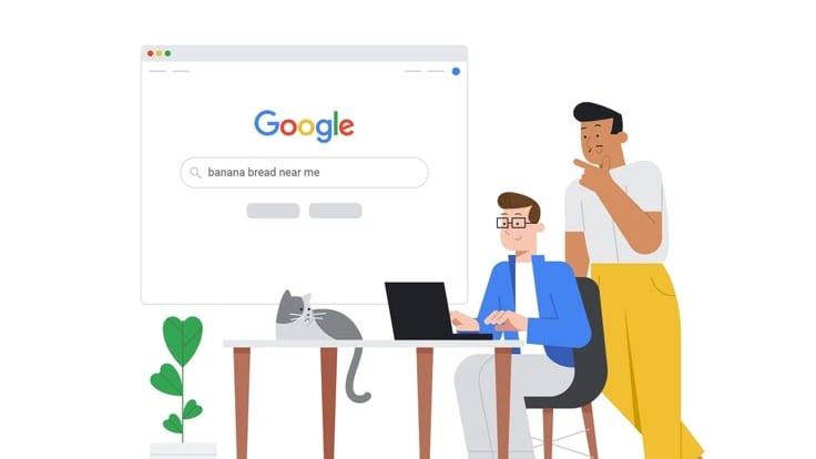 a man and woman sitting at a desk with a laptop