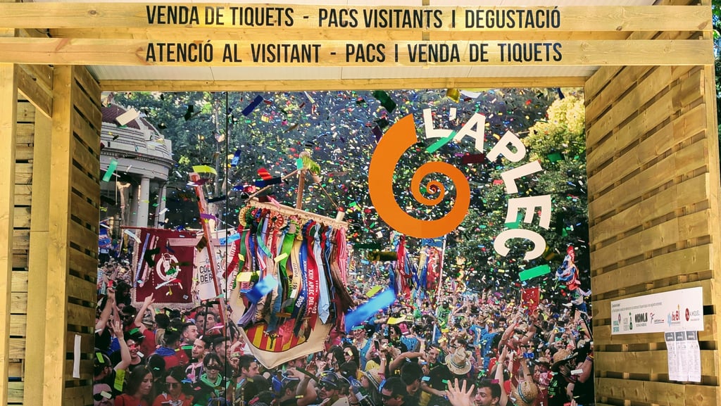 A vibrant festival booth at L’Aplec del Caragol featuring colorful decorations and confetti.