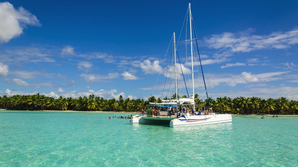 Catamaran tour in clear turquoise water at Saona Island, Dominican Republic
