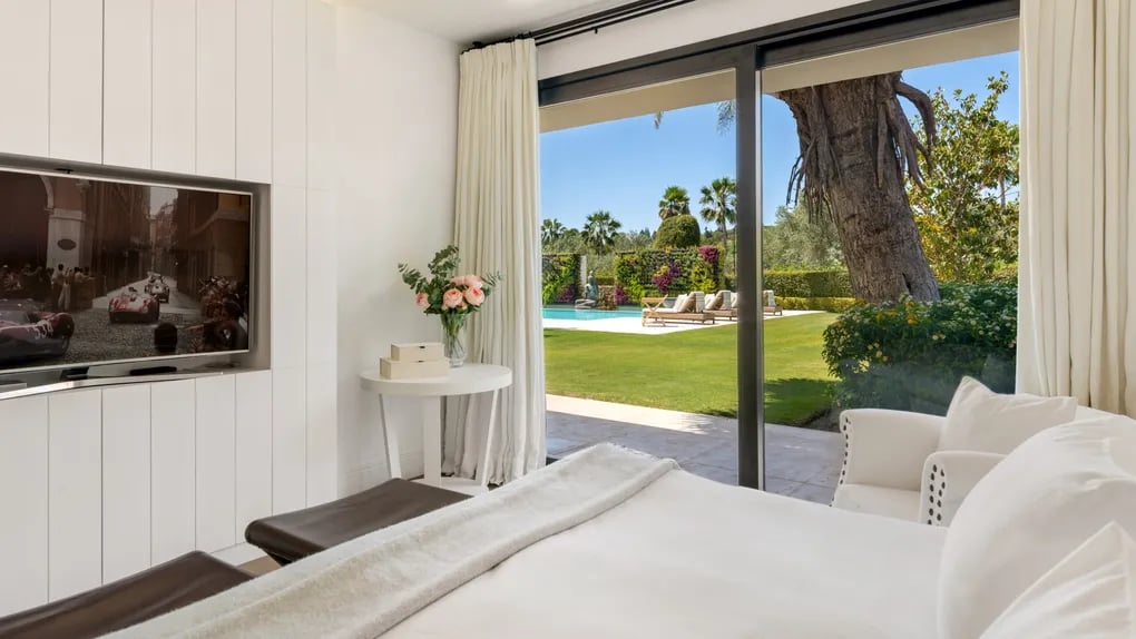 Guest suite with garden views and modern interior design at Villa El Olivo, Marbella