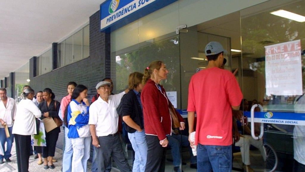 a group of people standing in line at a bank
