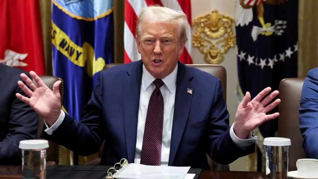 a man in a suit and tie is sitting at a table