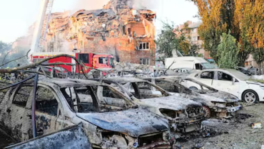 a firefighter standing in front of a building with a fire hydrant