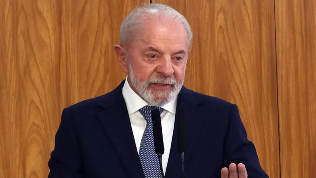 a man in a suit and tie is speaking into a microphone