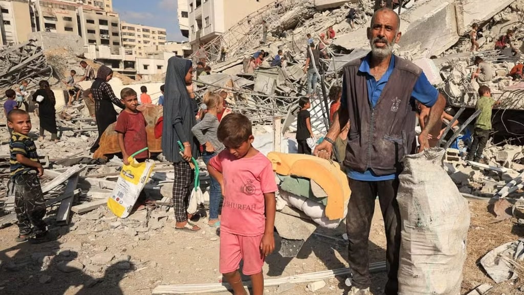 a man standing in front of a pile of rubble