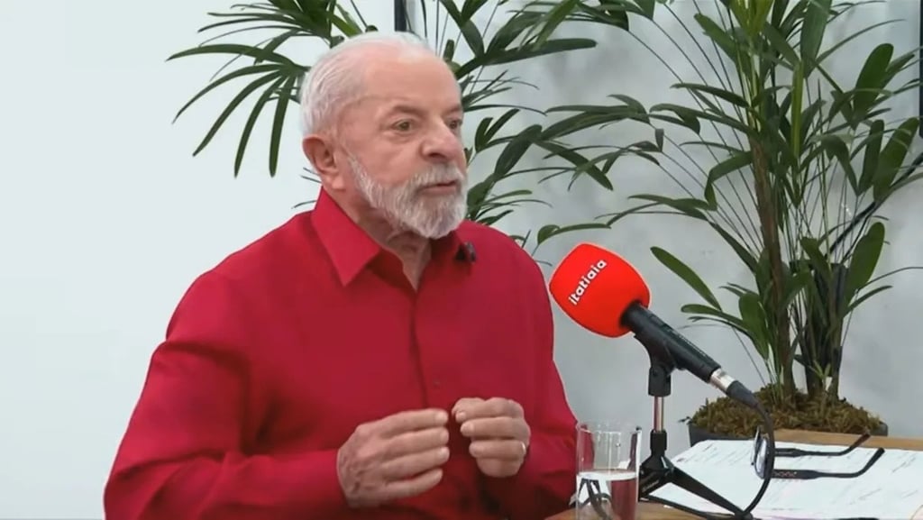a man in a red shirt and microphone