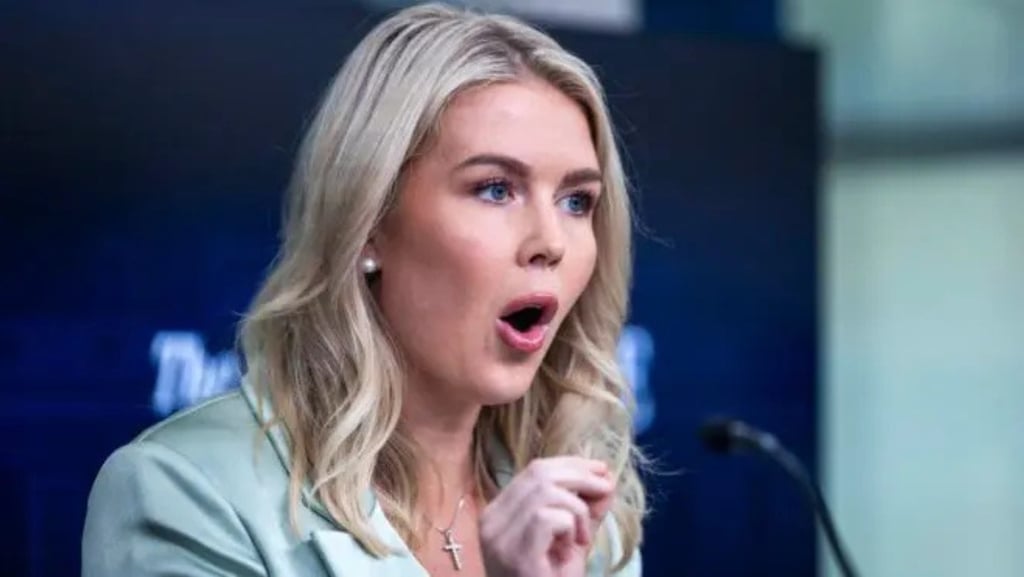 a woman in a green jacket and a microphone