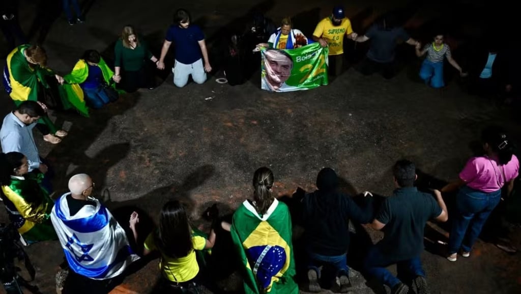 a group of people standing around a circle of flags