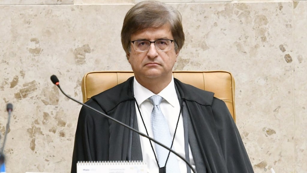 a man in a suit and tie is sitting at a desk