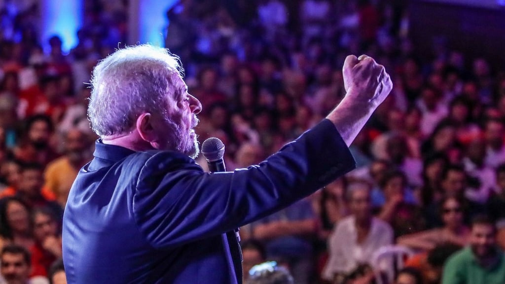 a man in a blue jacket and a microphone