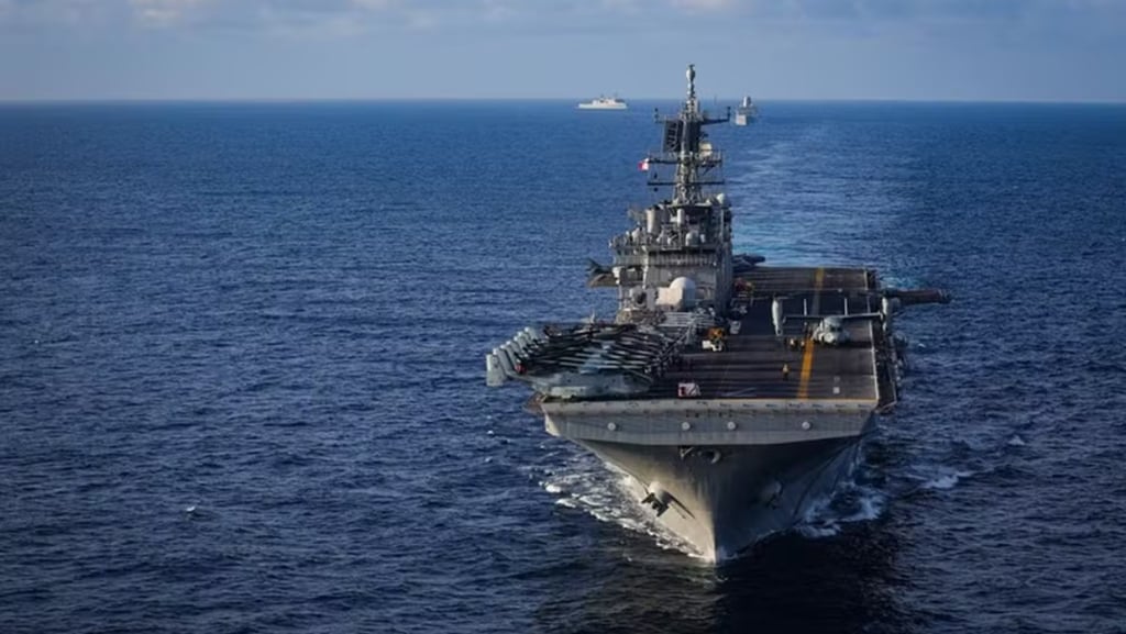 a large ship in the water with a large ship in the background