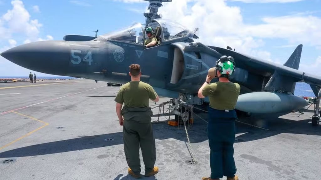 two men standing on a deck of a ship