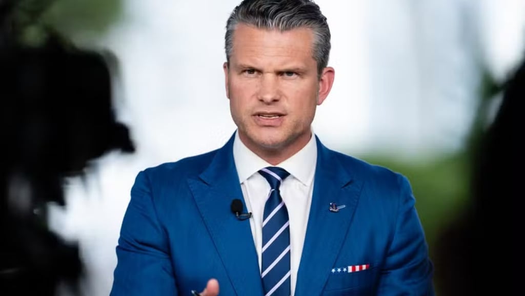 a man in a blue suit and tie with a microphone