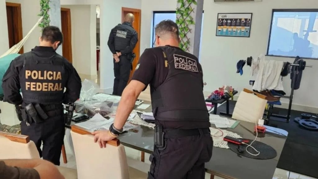 a police officer standing in a room with a table and chairs