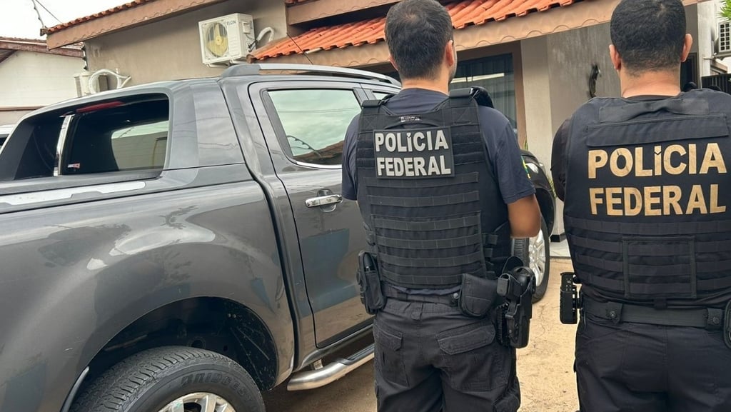 two police officers standing in front of a truck