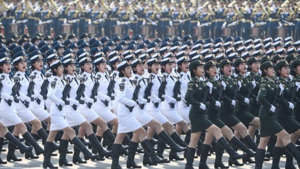 a group of women in uniform uniforms marching a parade