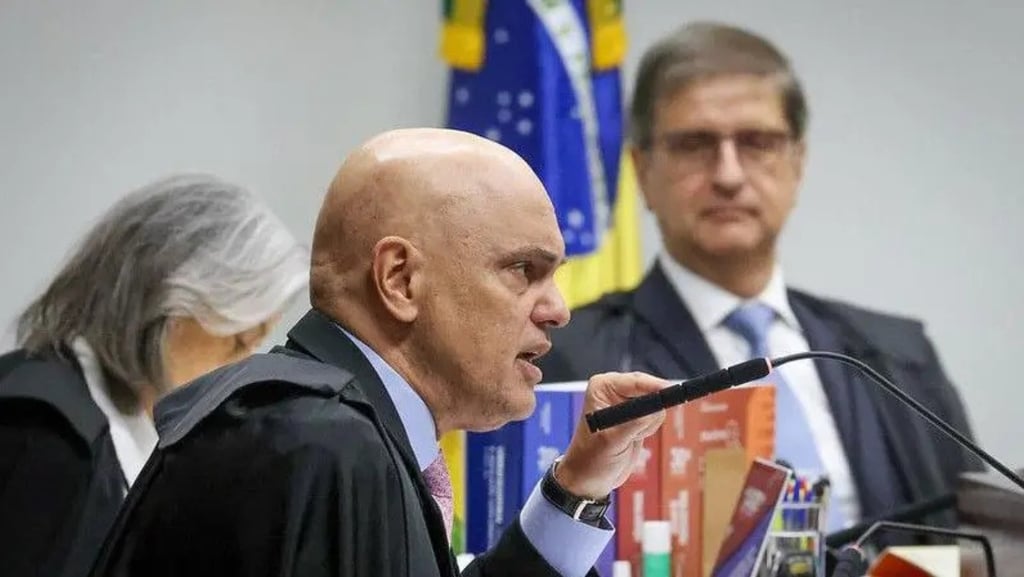 a man in a suit and tie is speaking into a microphone