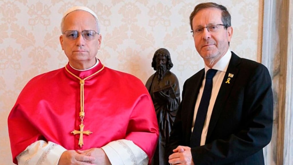 a man in a suit and tie standing next to a statue of a man in