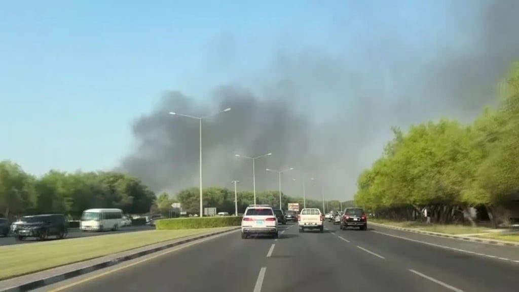 a large plume of smoke billowing through the air