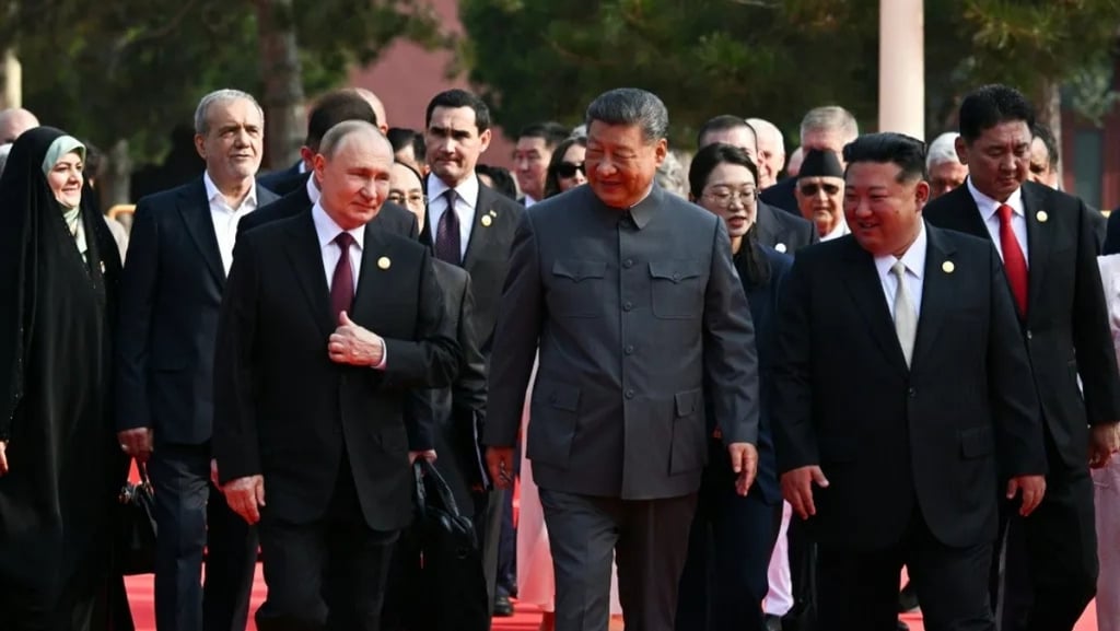 a group of men in suits and ties walking down a red carpet
