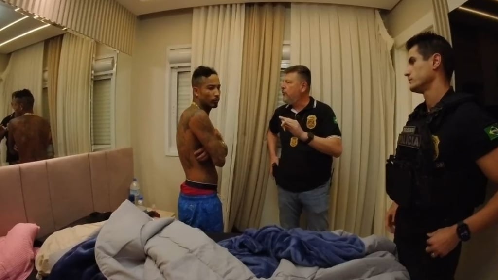 a man in a police uniform is standing in a room