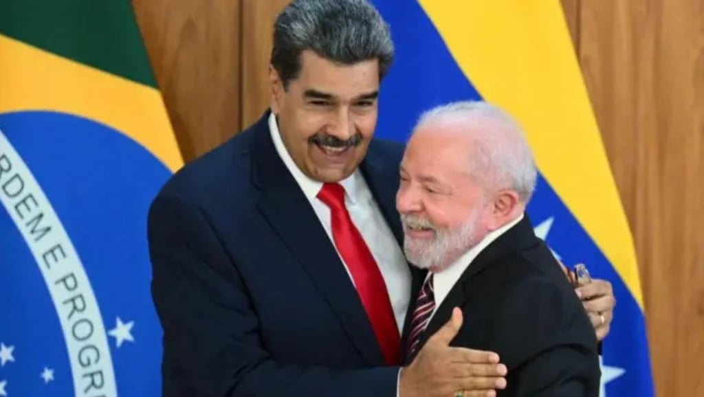 a man in a suit and tie is hugging a man in a suit