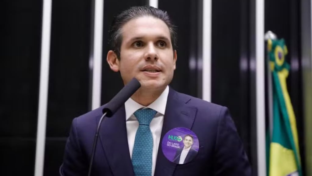 a man in a suit and tie with a microphone