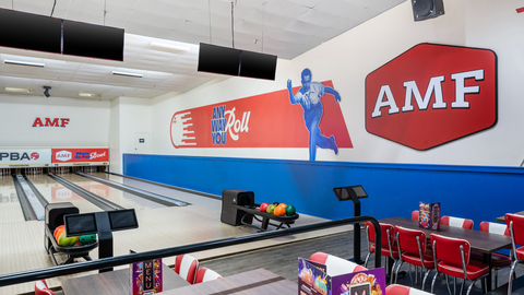 A clean interior view of an AMF bowling alley with modern lanes, ball returns, and seating areas.