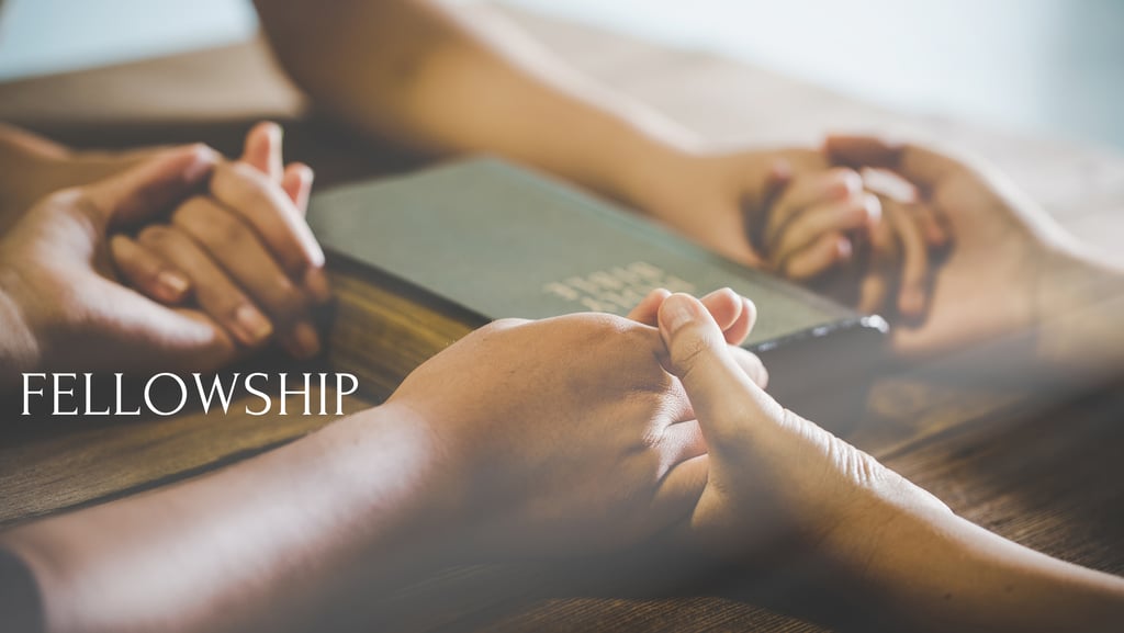 friends holding hands at a table with the Bible in the center with the word fellowship