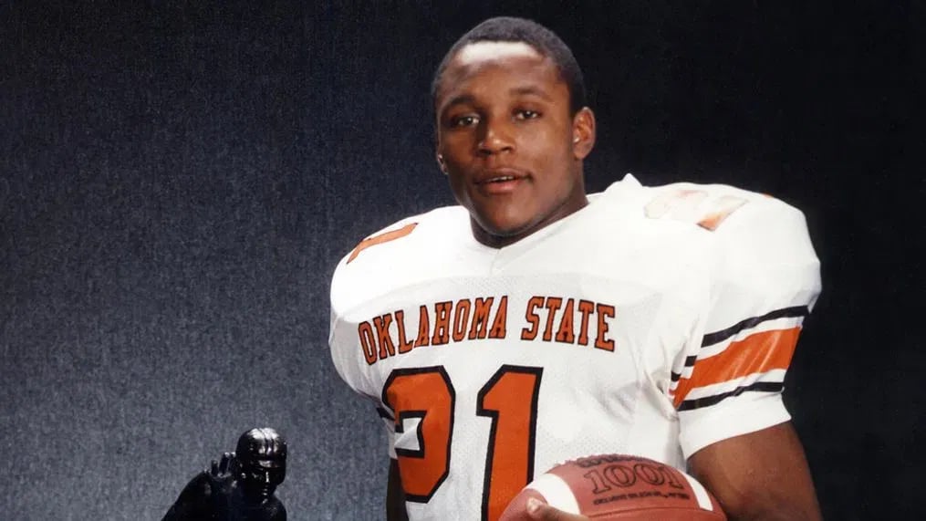 Barry Sanders posing with his Heisman Trophy in 1988.