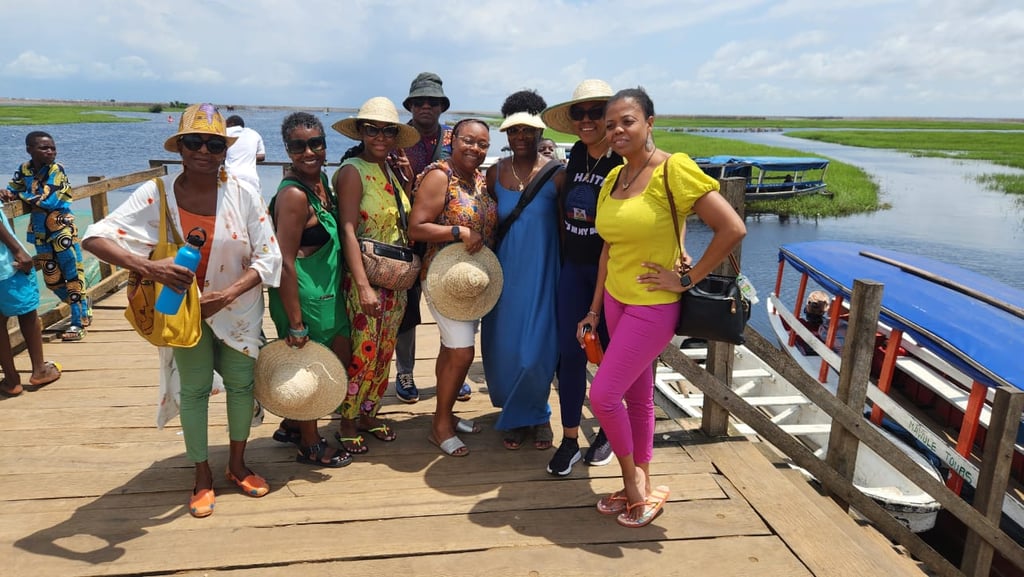 Haitian Diasporas visiting Ganvie Stilt Village in Benin during A multi-country tours