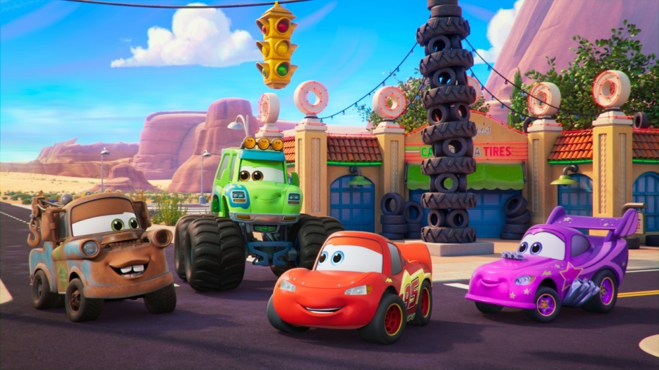 Disney Cars cast in front of Radiator Springs backdrop.