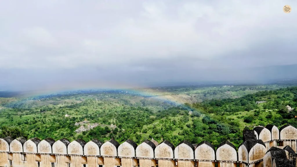 Rainbow visible from Badal Mahal at Kumbhalgarh Fort, overlooking the lush Aravalli hills and fort surroundings.