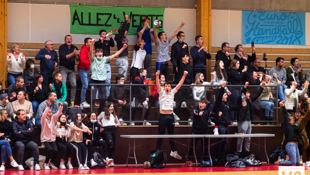 a group of people standing in front of a crowd of people