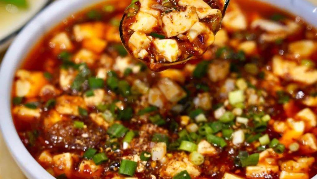 a spoonful of soup with a spoonful of Mapo Tofu