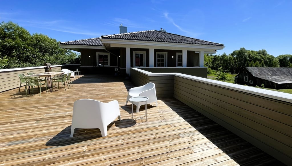 big sunny balcony terrace with furniture for dining and relaxing