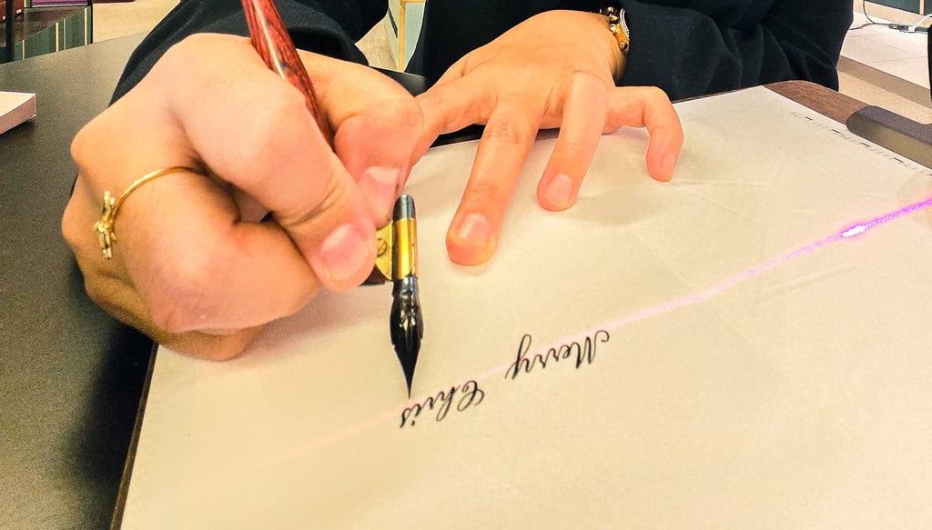 Live calligrapher performing calligraphy for luxury brand activation