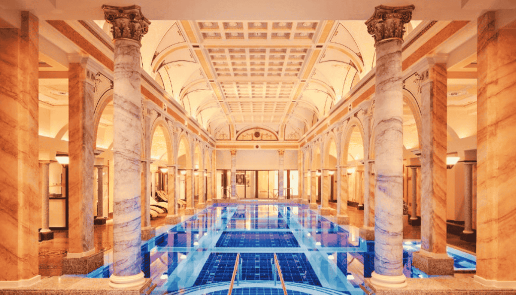 wellness hotel with a large indoor swimming pool with a blue tiled floor