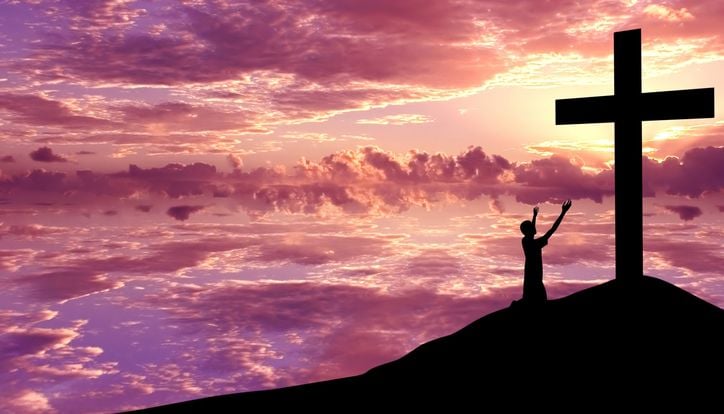kid beneath the cross