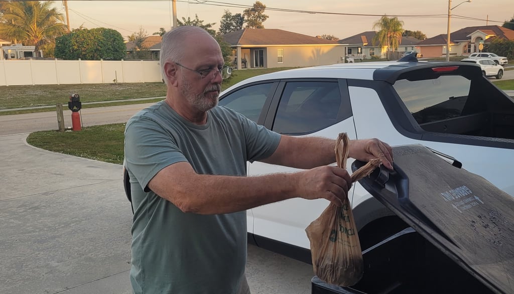 Robert placing dog waste in trash bin in psl