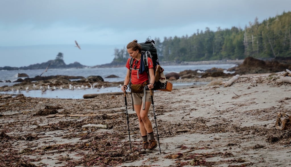 a man with a backpacker walking on a beach