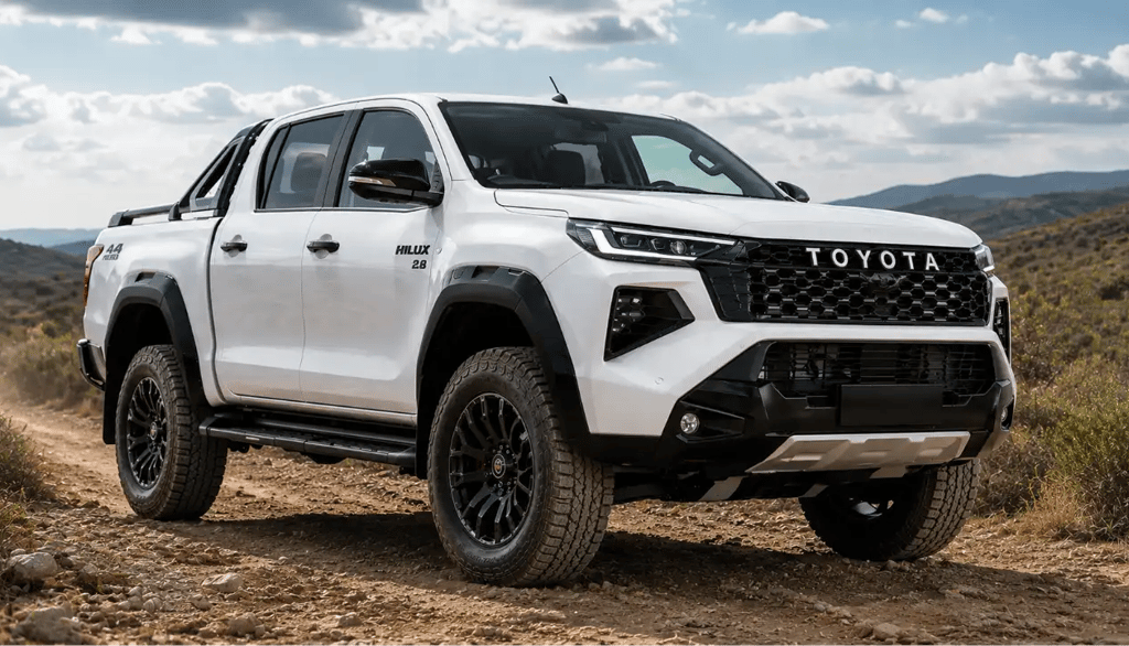 Toyota Hilux 2027 branca em estrada de terra e cascalho com vegetação rasteira