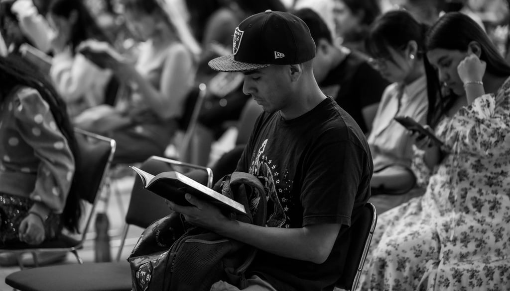 a man sitting in a chair with a bible in his lap