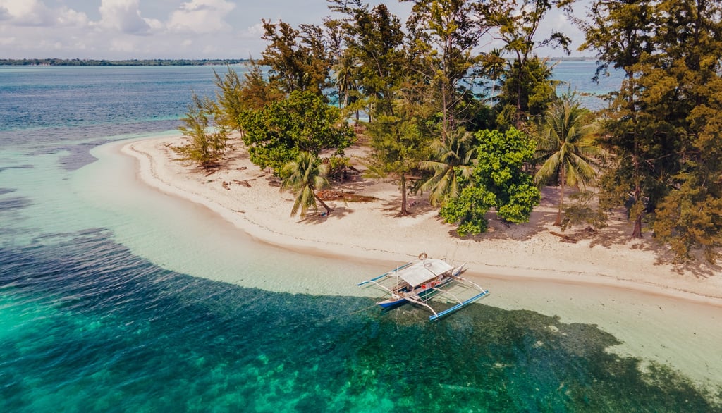 a boat is sitting on a small island