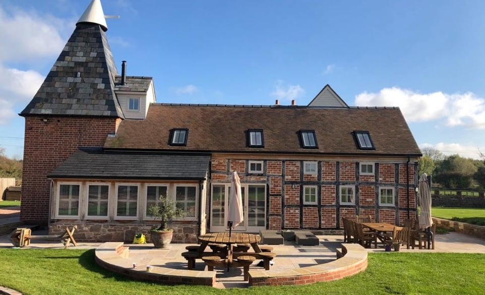 a large brick building with a table and chairs