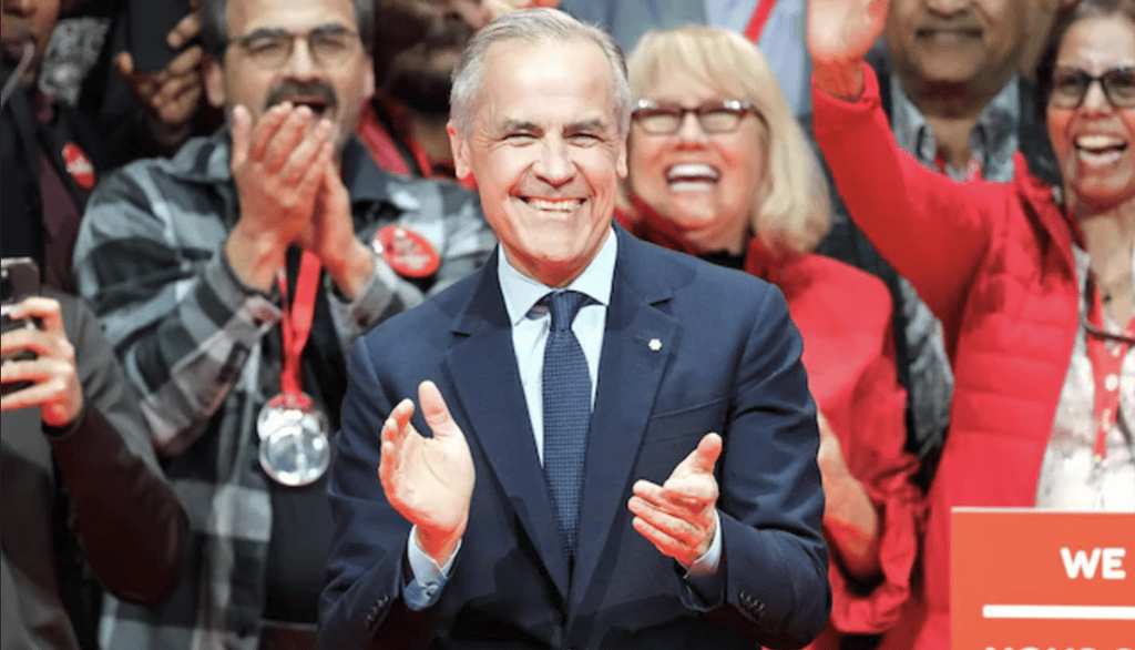 a man in a suit and tie is standing in front of a crowd of people