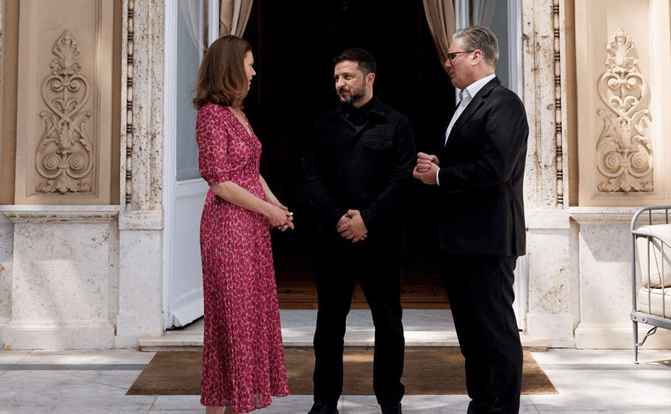 a man and woman shaking hands in front of a doorway