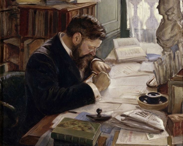 a man sitting at a table with a book and a book