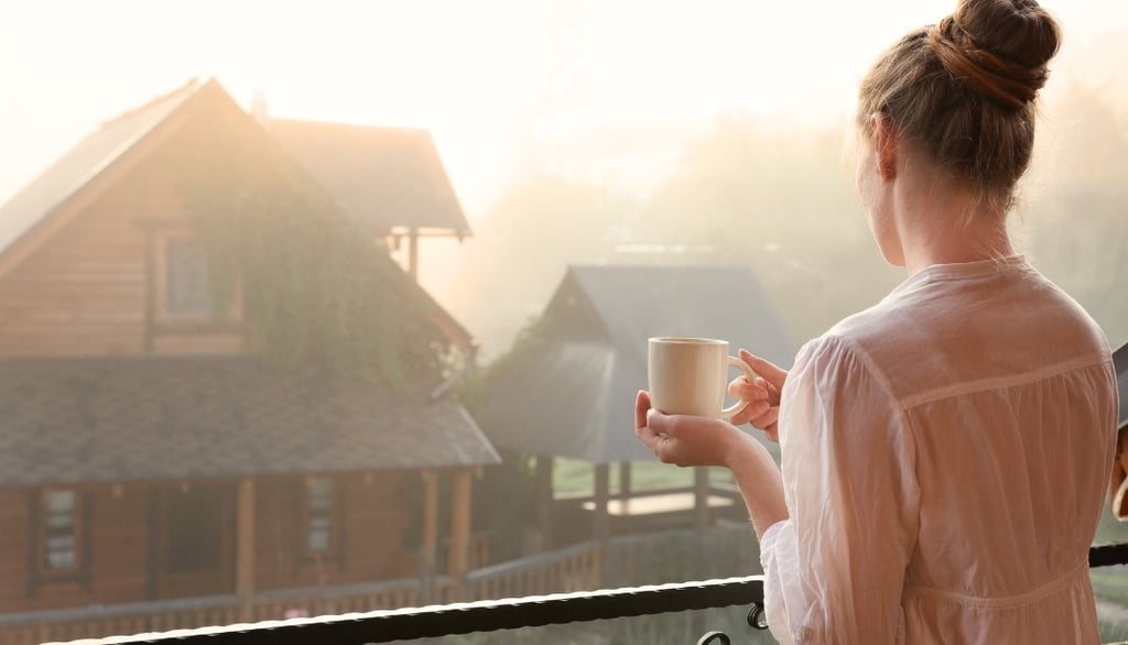 Woman practicing a self-care routine with a peaceful morning tea and mindful moment at home.